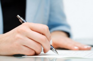 Businesswoman signing the contract.